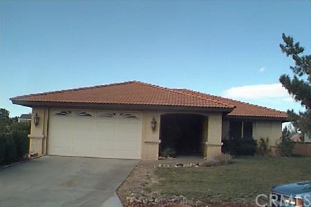 12876 Fairway Road Victorville, CA 92395 - Photo 1 of 1 a front view of a house with garden