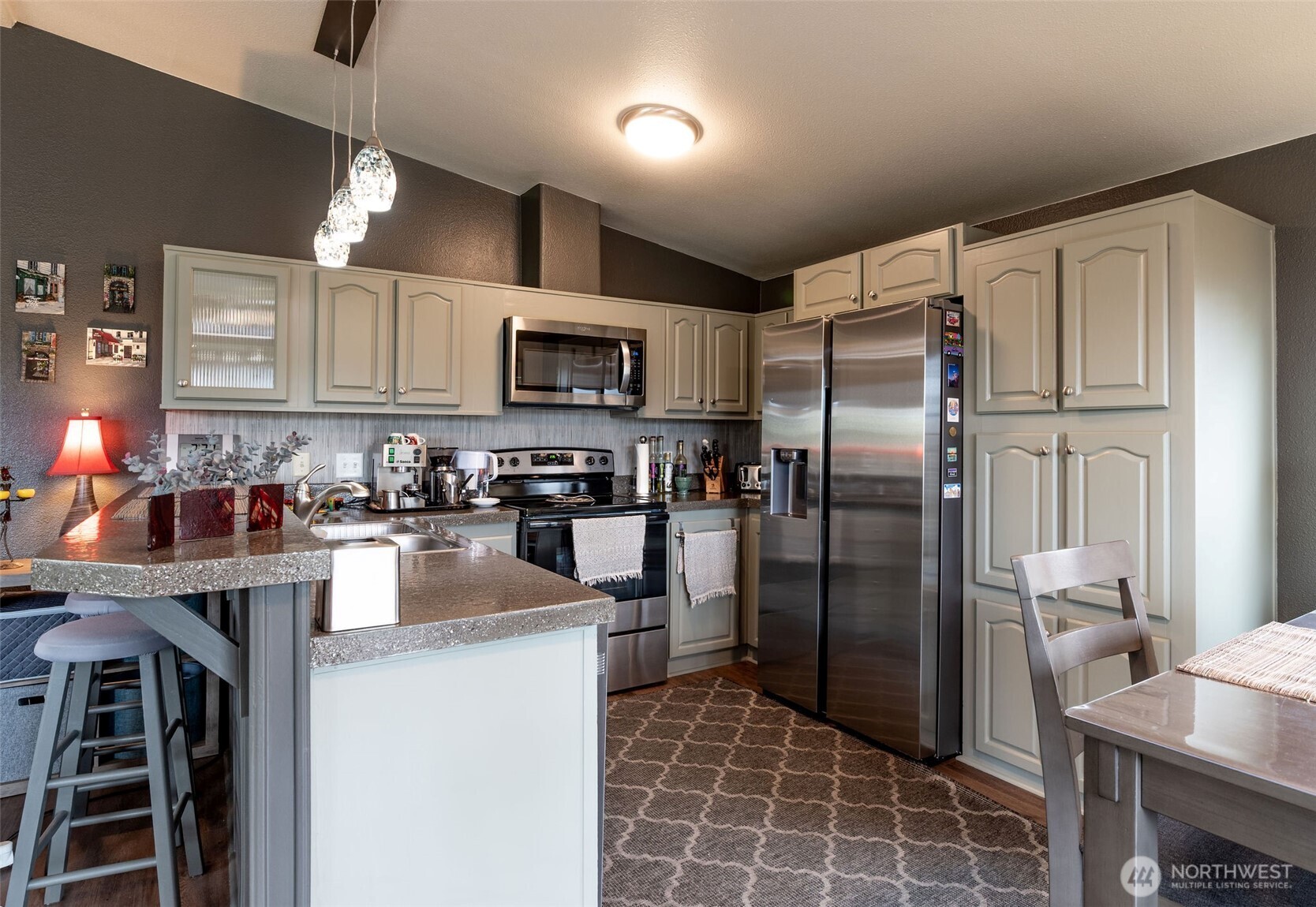 600 Northeast Lincoln Road, Unit 4 Poulsbo, WA 98370 - Photo 11 of 30 a kitchen with kitchen island a counter top space cabinets and stainless steel appliances