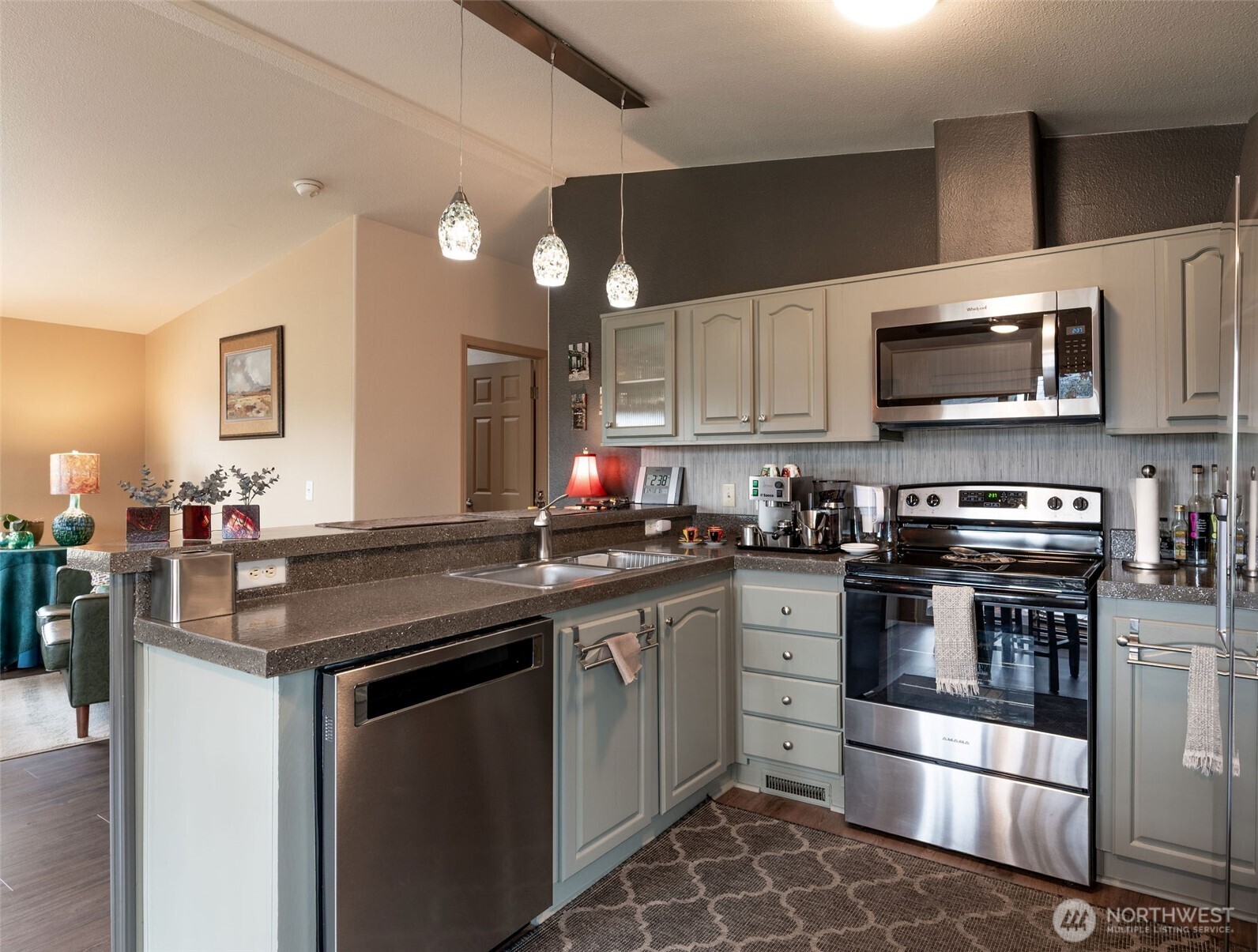 600 Northeast Lincoln Road, Unit 4 Poulsbo, WA 98370 - Photo 12 of 30 a kitchen with stainless steel appliances a stove sink microwave and cabinets