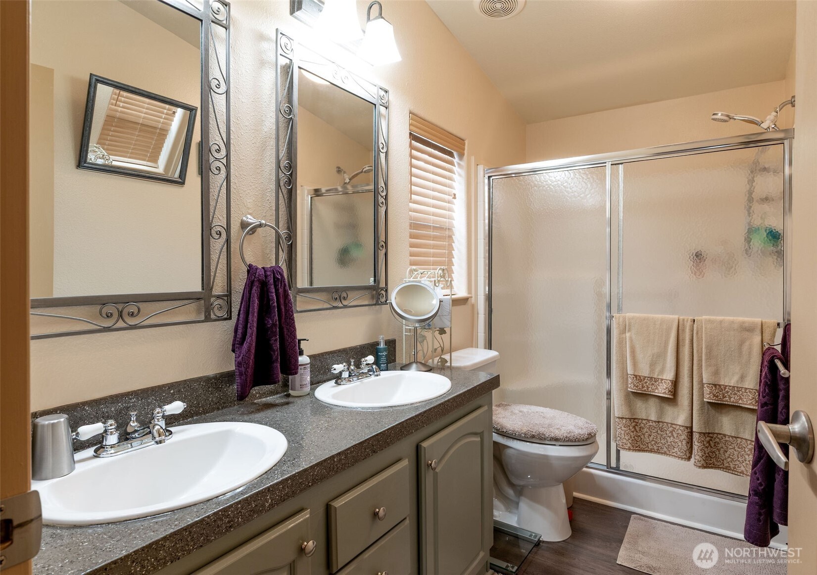 600 Northeast Lincoln Road, Unit 4 Poulsbo, WA 98370 - Photo 17 of 30 a bathroom with a double vanity sink toilet mirror and shower