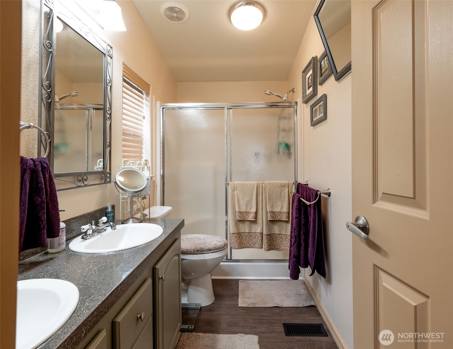 600 Northeast Lincoln Road, Unit 4 Poulsbo, WA 98370 - Photo 18 of 30 a bathroom with a sink a toilet a mirror and shower