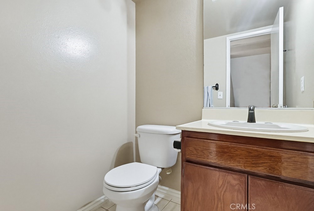 19018 Sherman Way, Unit 110 Reseda, CA 91335 - Photo 24 of 68 a bathroom with a sink a toilet and mirror