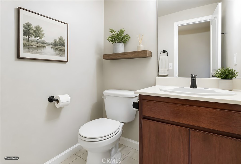 19018 Sherman Way, Unit 110 Reseda, CA 91335 - Photo 25 of 68 a bathroom with a sink mirror and toilet