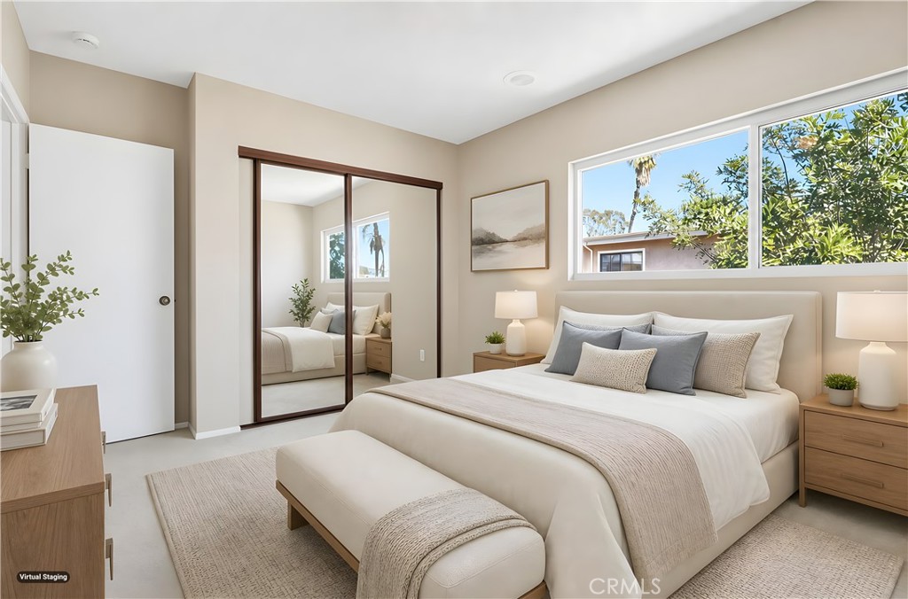19018 Sherman Way, Unit 110 Reseda, CA 91335 - Photo 34 of 68 a bedroom with a large bed and a potted plant
