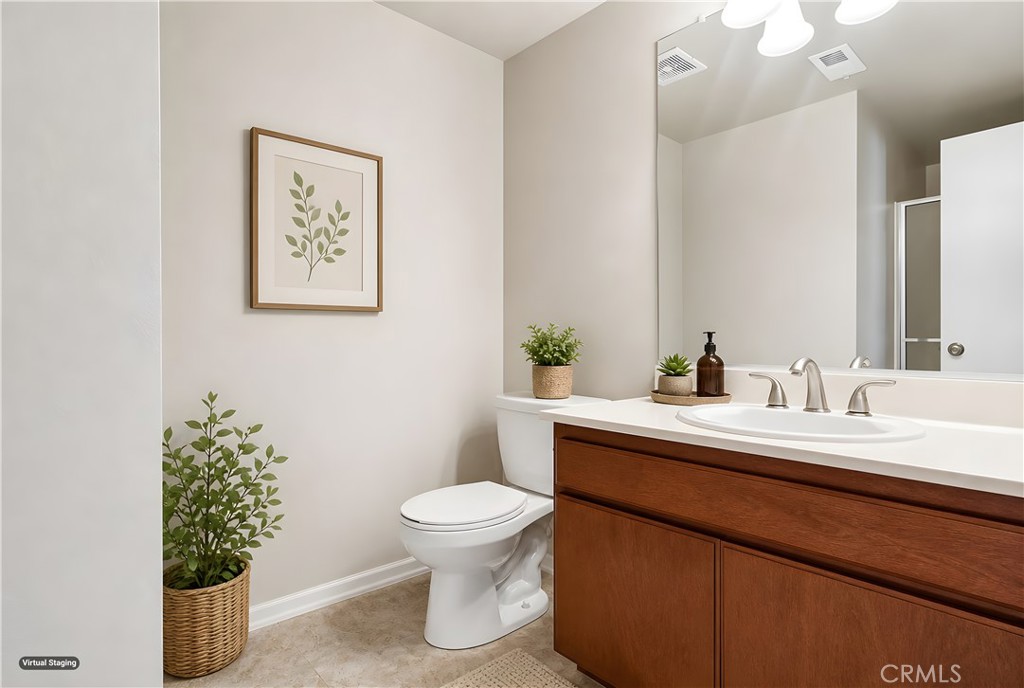 19018 Sherman Way, Unit 110 Reseda, CA 91335 - Photo 36 of 68 a bathroom with a toilet sink and mirror