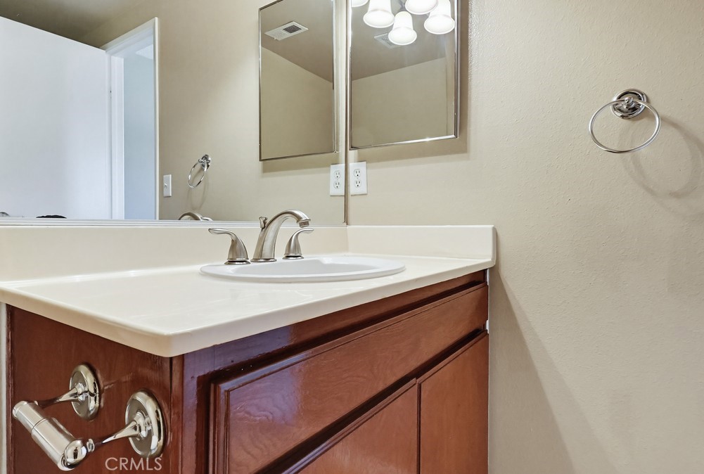 19018 Sherman Way, Unit 110 Reseda, CA 91335 - Photo 37 of 68 a bathroom with a sink and a mirror