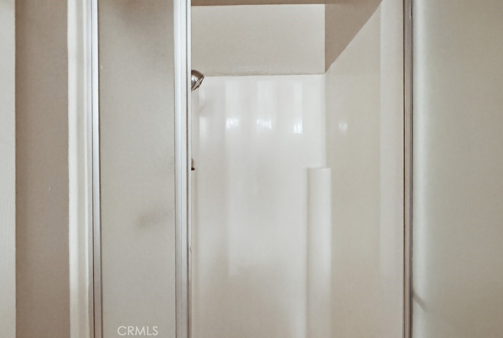 19018 Sherman Way, Unit 110 Reseda, CA 91335 - Photo 38 of 68 a bathroom with a glass shower door