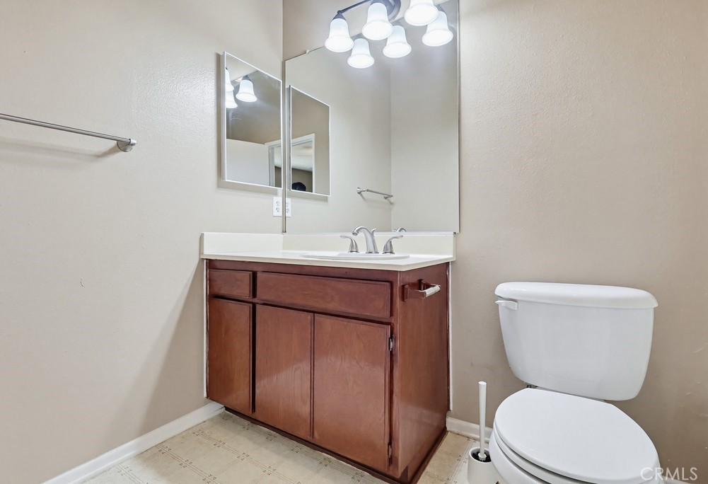 19018 Sherman Way, Unit 110 Reseda, CA 91335 - Photo 47 of 68 a bathroom with a toilet sink and mirror