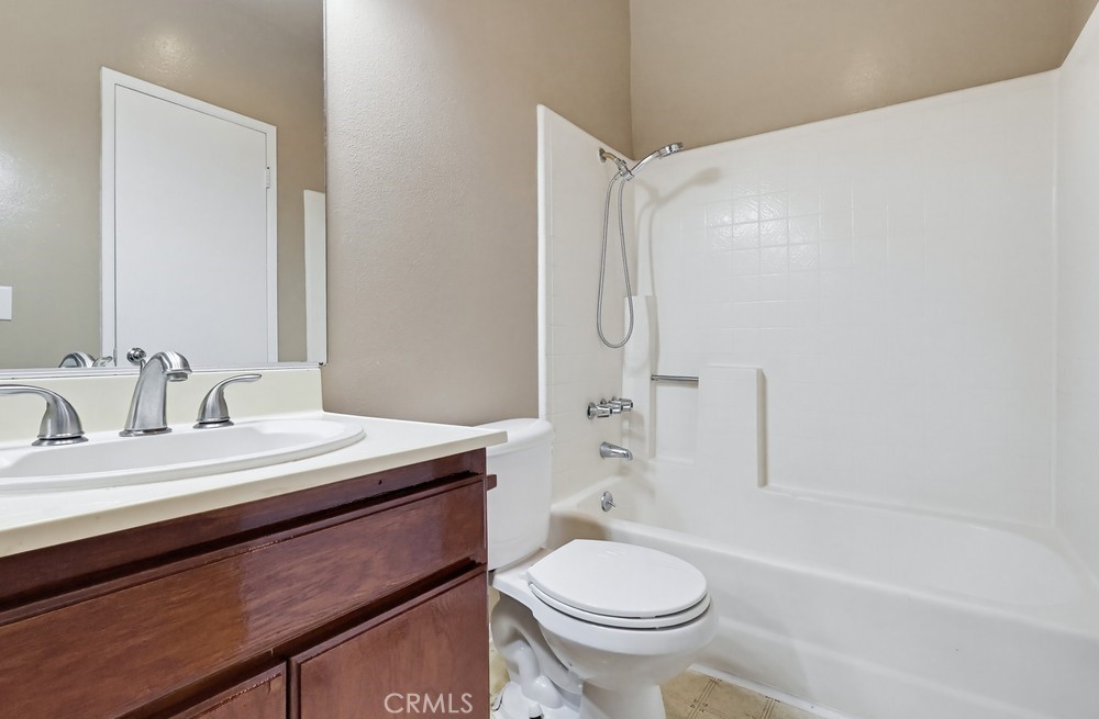 19018 Sherman Way, Unit 110 Reseda, CA 91335 - Photo 48 of 68 a bathroom with a sink a toilet and a bathtub