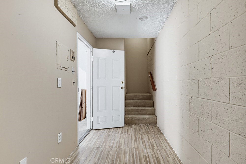 19018 Sherman Way, Unit 110 Reseda, CA 91335 - Photo 56 of 68 a view of a hallway with wooden floor and staircase