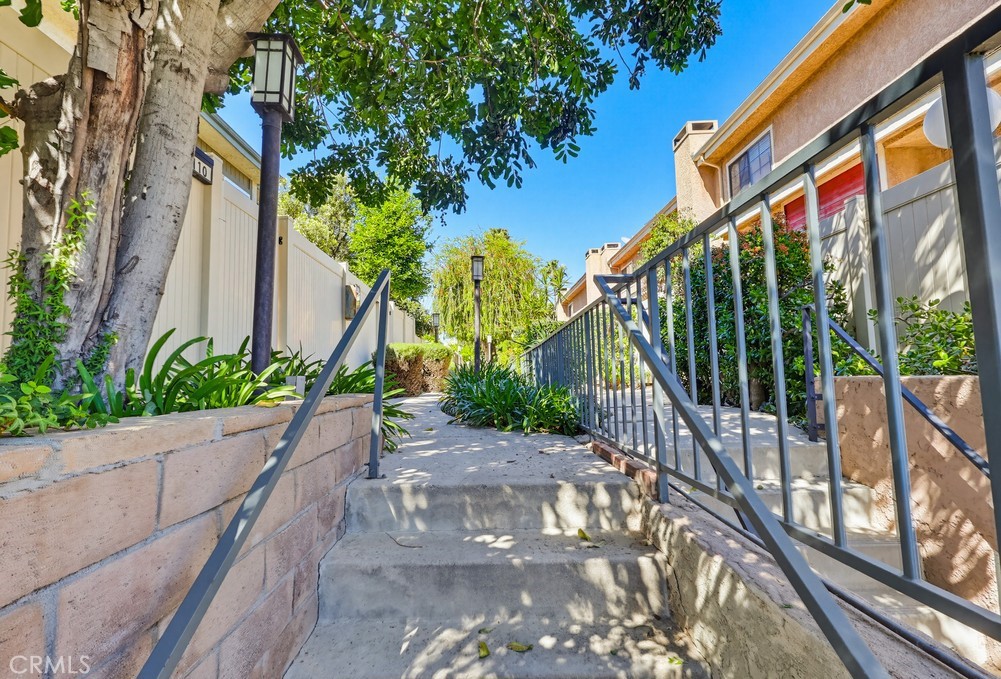 19018 Sherman Way, Unit 110 Reseda, CA 91335 - Photo 67 of 68 a view of a pathway of a house with a yard