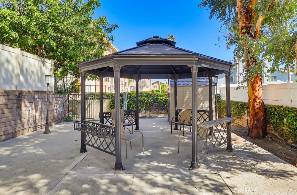 19018 Sherman Way, Unit 110 Reseda, CA 91335 - Photo 68 of 68 a view of a patio with a table chairs and backyard