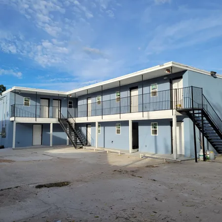 a front view of a house with a road