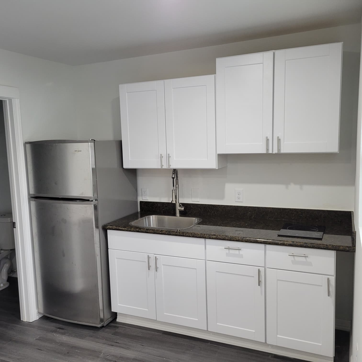 4312 Crane Street, Unit 11 Houston, TX 77026 - Photo 2 of 13 a kitchen with granite countertop white cabinets and refrigerator