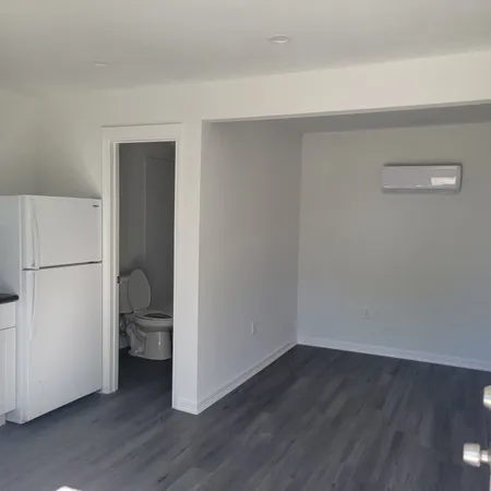 a view of a room with wooden floor and a sink