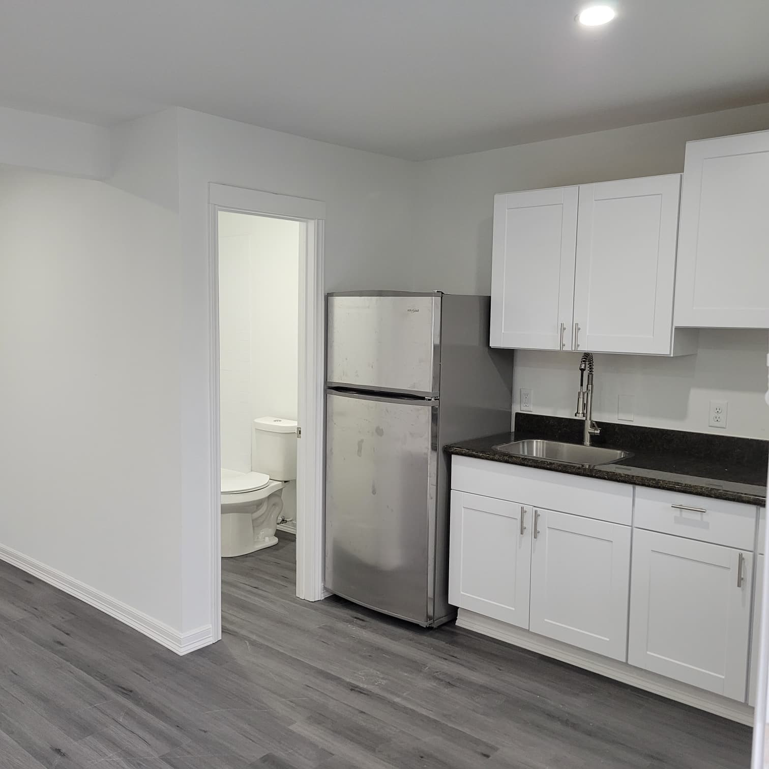 4312 Crane Street, Unit 11 Houston, TX 77026 - Photo 7 of 13 a kitchen with a sink a refrigerator and cabinets