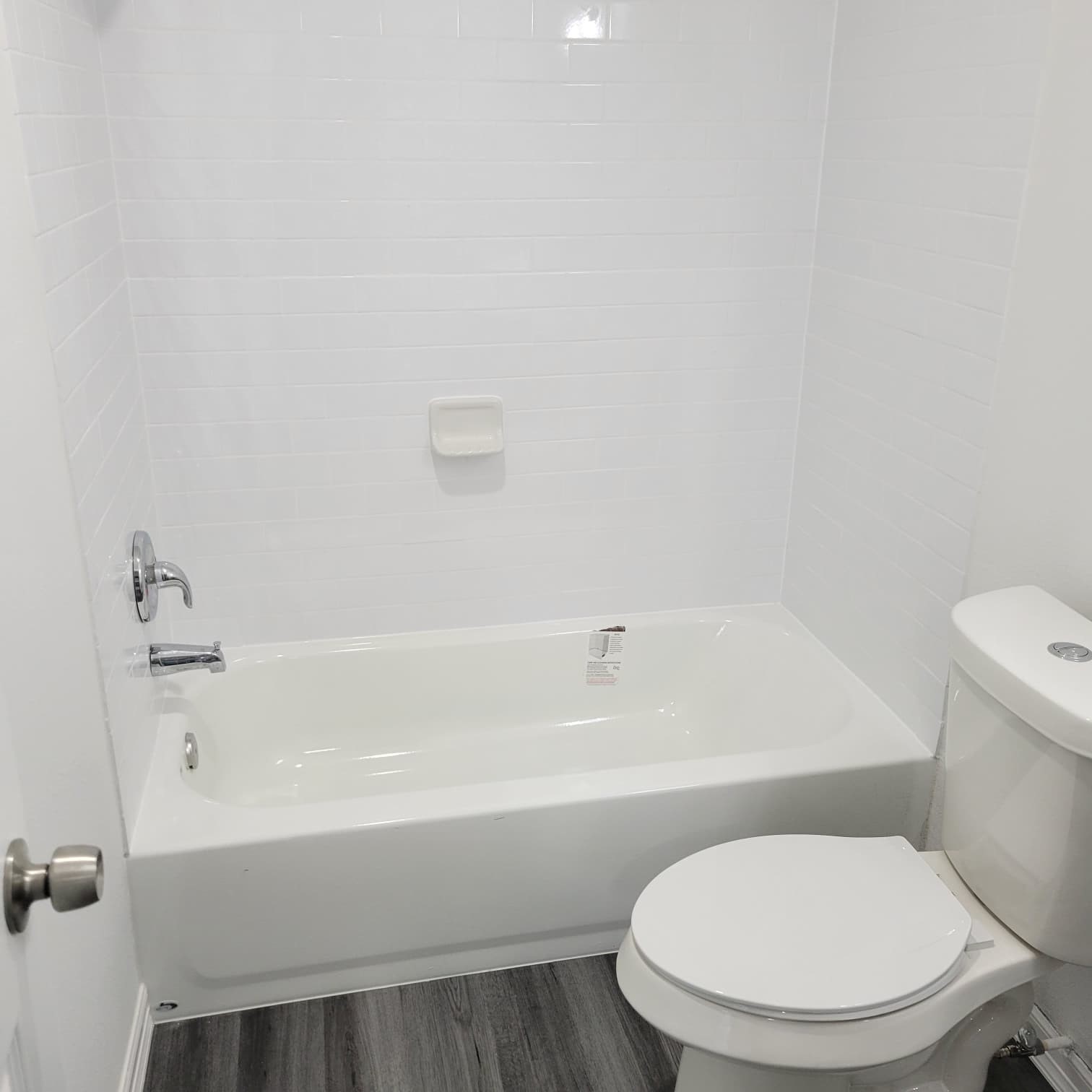 4312 Crane Street, Unit 11 Houston, TX 77026 - Photo 10 of 13 a white toilet sitting next to a bath tub