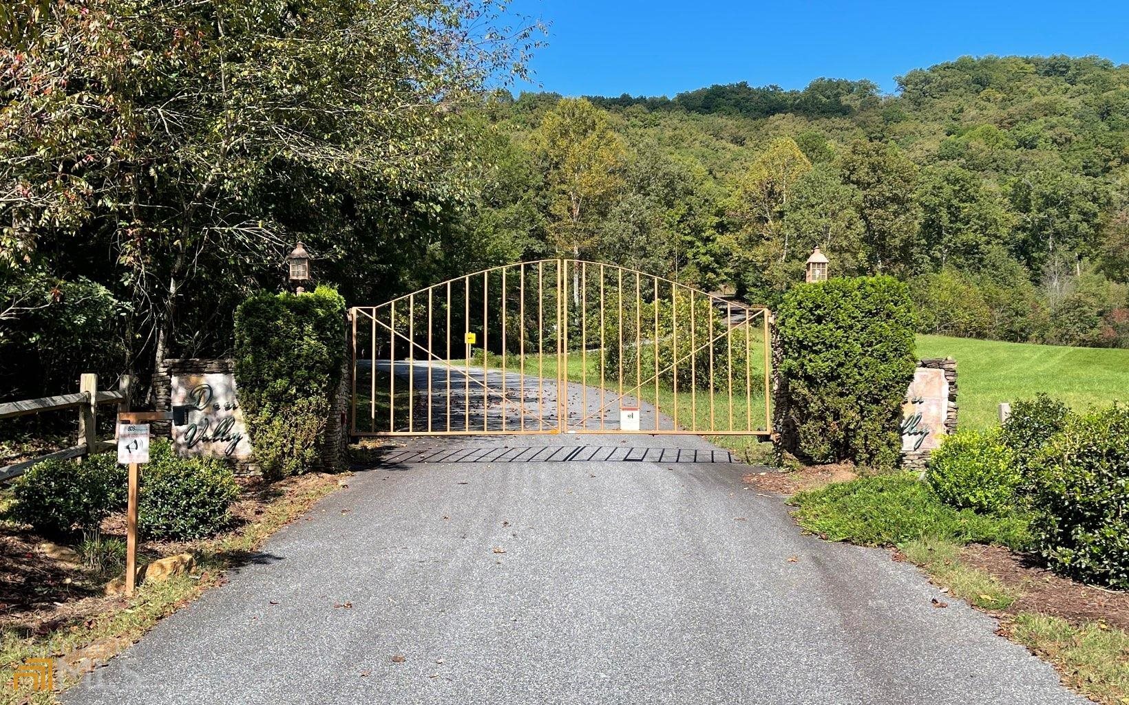 a view of a pathway with a wrought fence