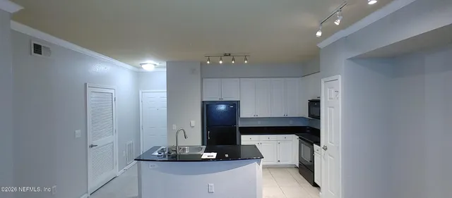 a living room with a sink and a mirror