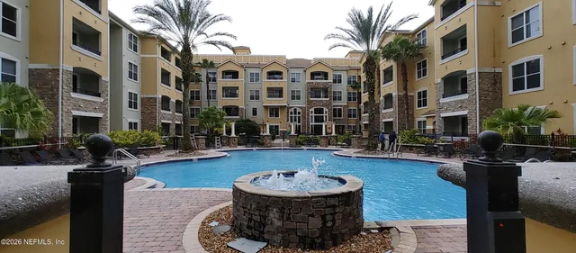 a front view of a building with outdoor seating
