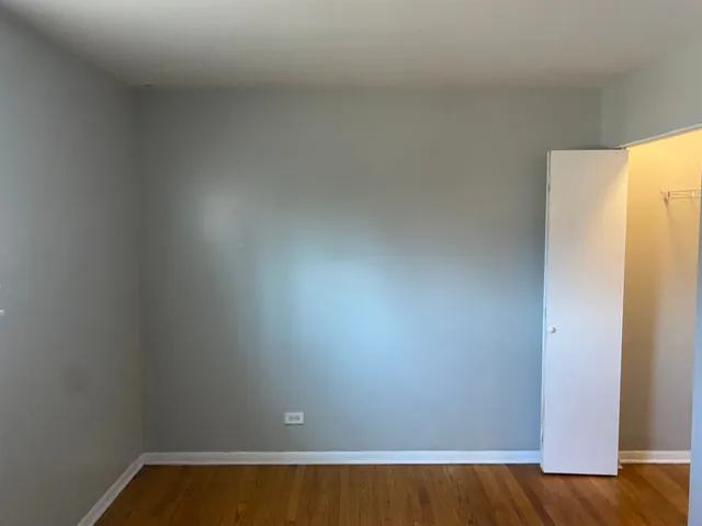 a view of small space with wooden floor and a window