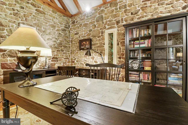 a dining hall with stainless steel appliances granite countertop a stove a sink a dining table and chairs with wooden floor