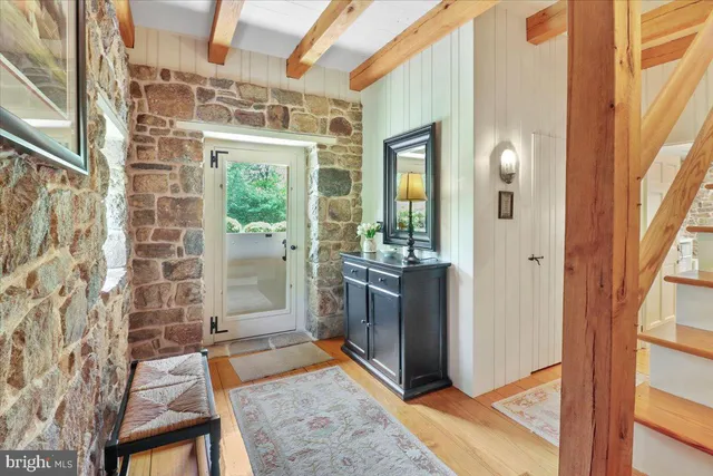 a living room with furniture a flat screen tv and a floor to ceiling window
