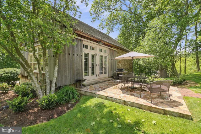 a view of patio with table and chairs under an umbrella