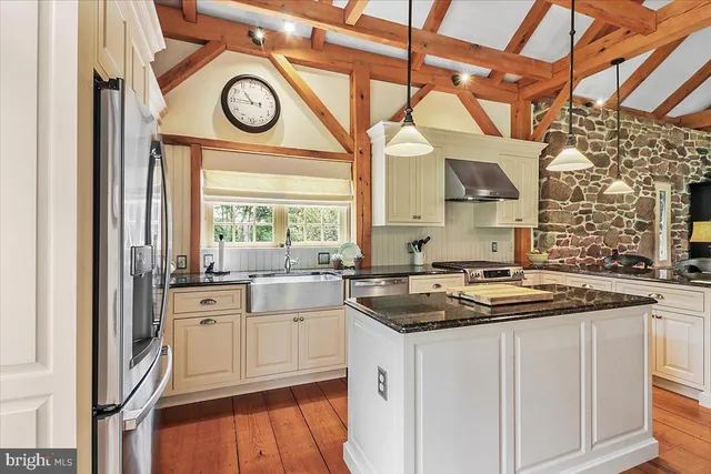 a kitchen with stainless steel appliances granite countertop a stove and a sink