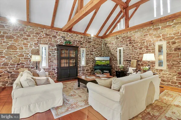 a view of a dining room with furniture large windows and wooden floor