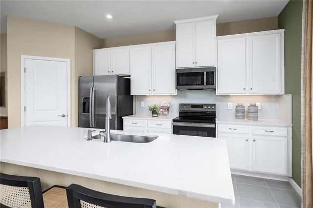 a kitchen with a sink a stove and refrigerator