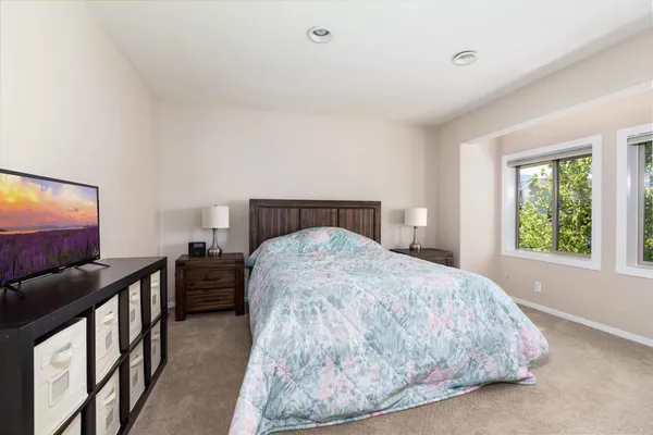 a bathroom with a granite countertop sink a mirror and shower