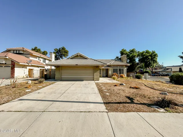 a view of a house with snow on the road