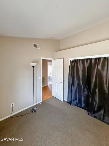 a view of walk in closet with clothes