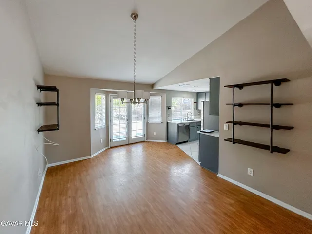 a view of a room with wooden floor and windows