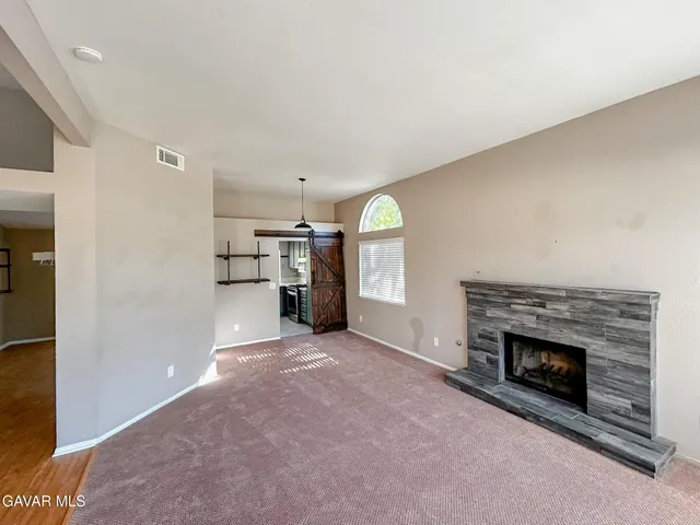 an empty room with furniture and a fireplace