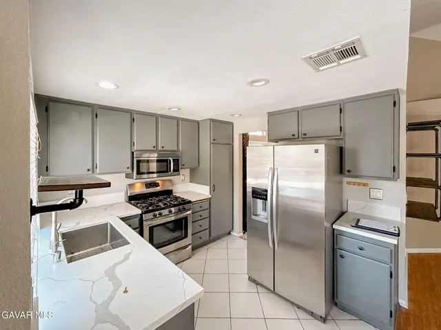 a kitchen with a refrigerator sink and microwave
