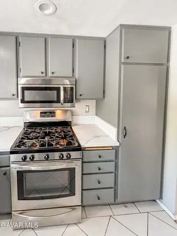 a kitchen with a stove and a refrigerator