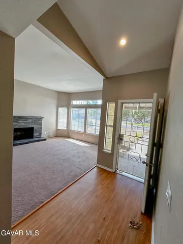 a big room with wooden floor and balcony