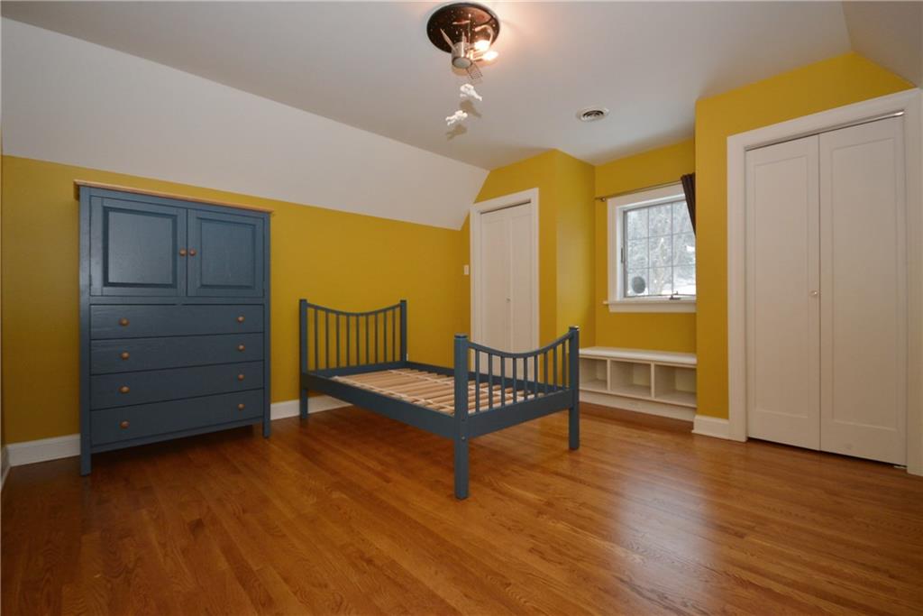 308 Bevington Road Forest Hills, PA 15221 - Photo 21 of 25 Second full bedroom off the second floor common room has beautiful hardwood floors and tons of closet space. Includes unique light fixture and bench seating in the window area.