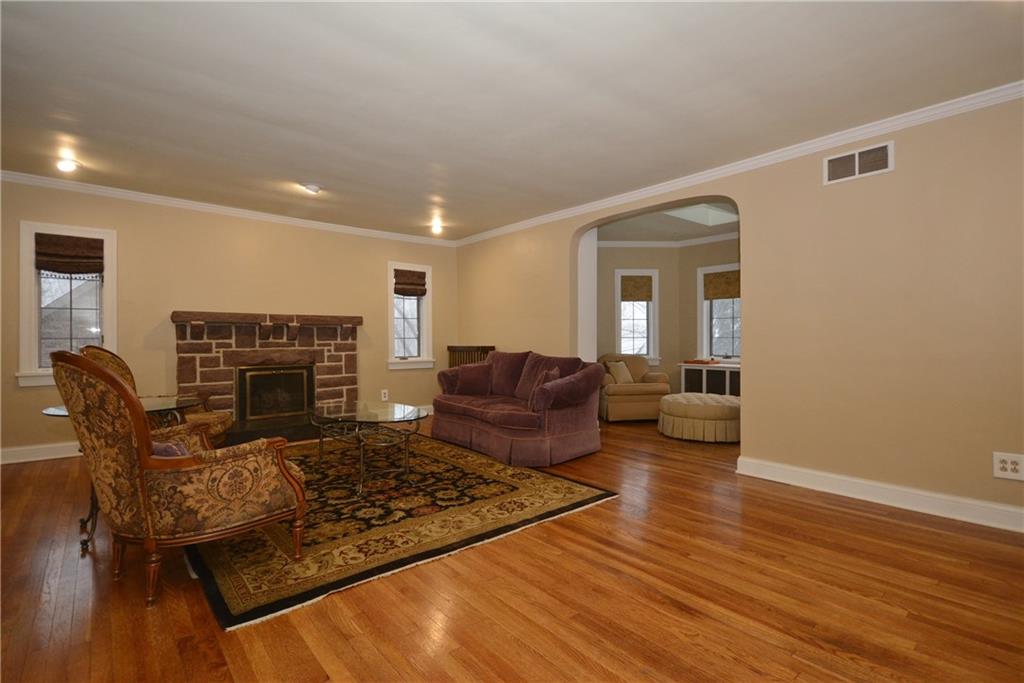 308 Bevington Road Forest Hills, PA 15221 - Photo 5 of 25 Expansive living room off the main entry with gas fireplace and original hardwoods. Entry to the sunroom on the right and open to dining room on the left. Bright, airy and freshly painted.