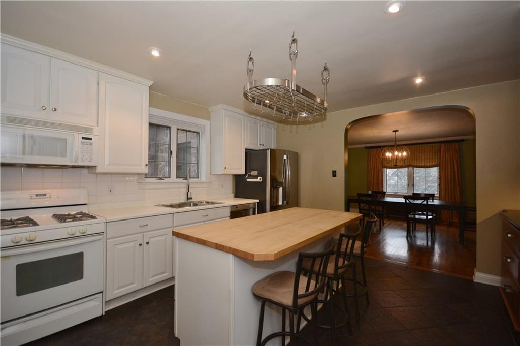 308 Bevington Road Forest Hills, PA 15221 - Photo 8 of 25 Bright and clean, this kitchen includes recessed lighting eat-in butcher block island, hanging pot rack, all appliances and lots of storage.