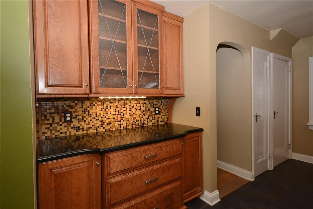 308 Bevington Road Forest Hills, PA 15221 - Photo 9 of 25 Additional custom cabinetry in the kitchen and tile backsplash. Easy access to front entry hall and basement.