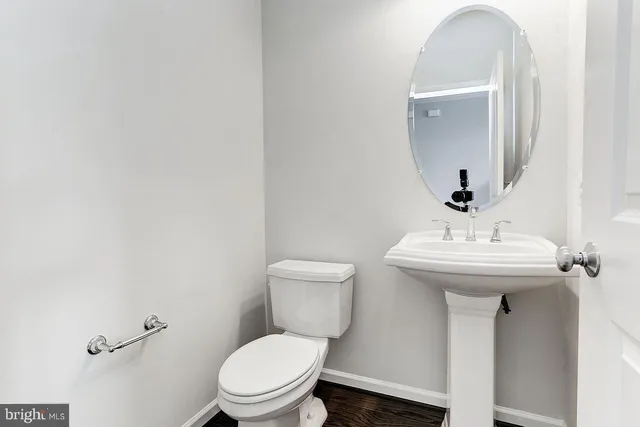 a bathroom with a toilet sink and mirror