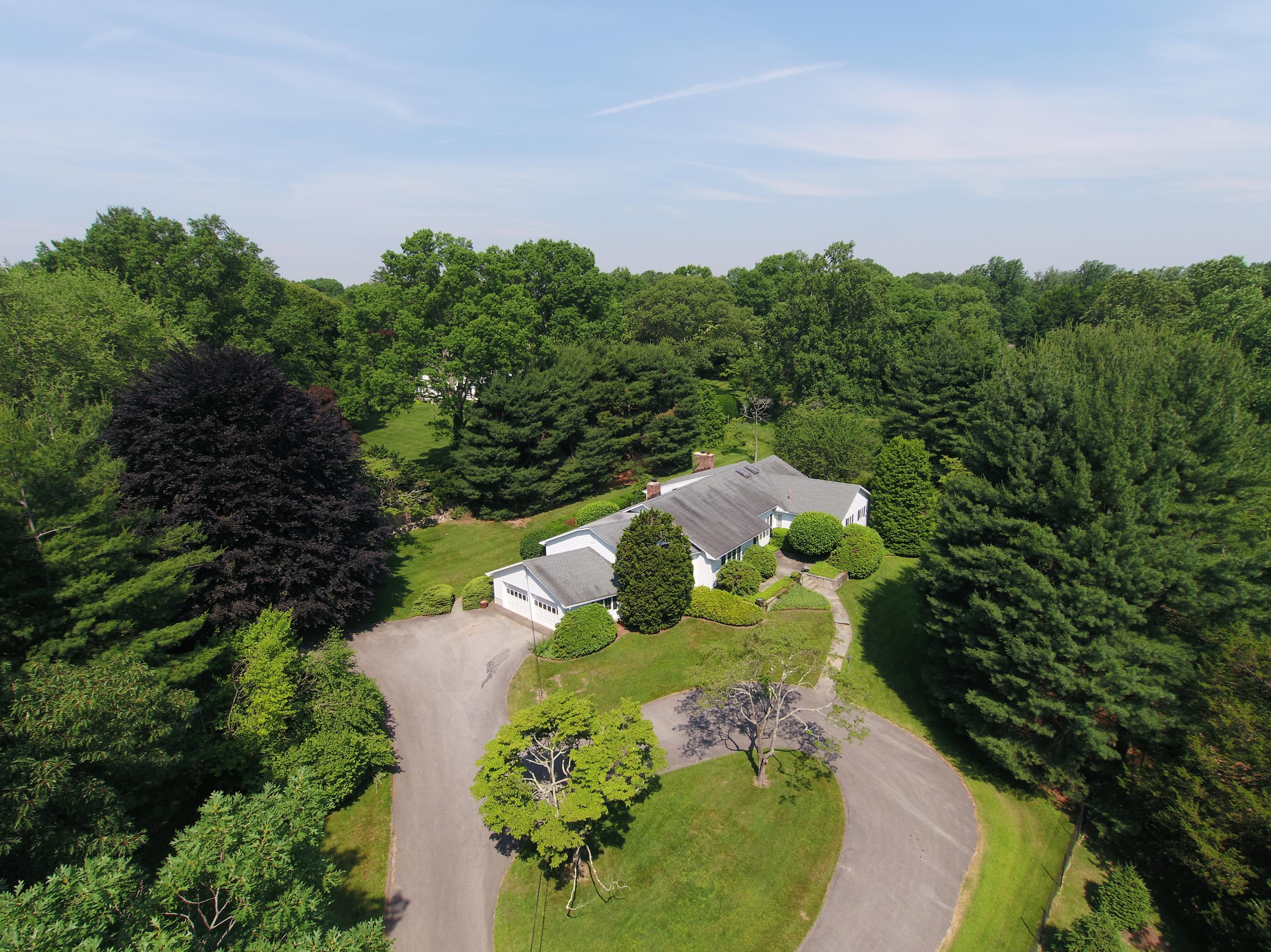 65 Maywood Road Darien, CT 06820 - Photo 1 of 14 a view of a garden with a fountain