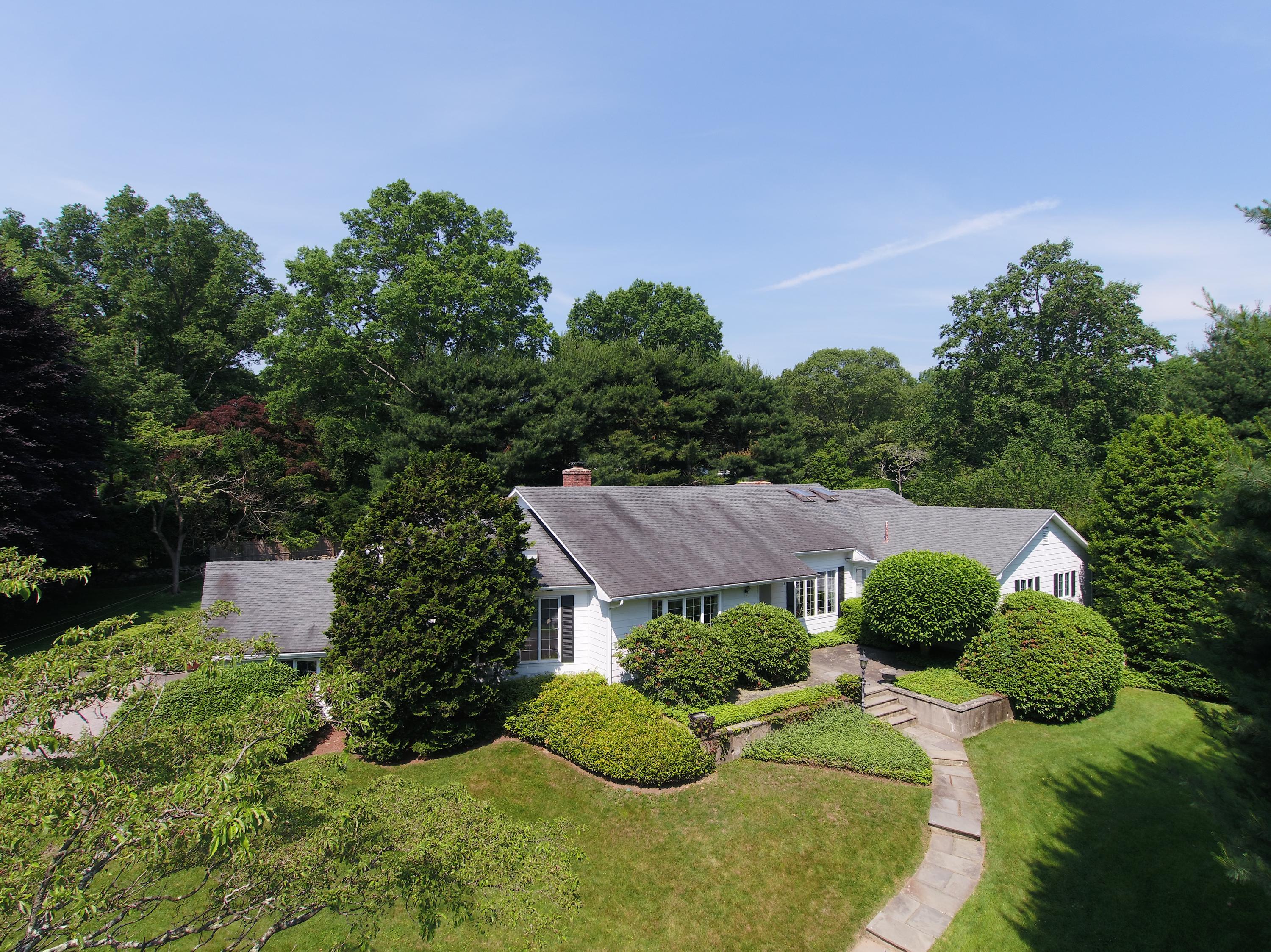 65 Maywood Road Darien, CT 06820 - Photo 3 of 14 a view of a house with a yard and potted plants