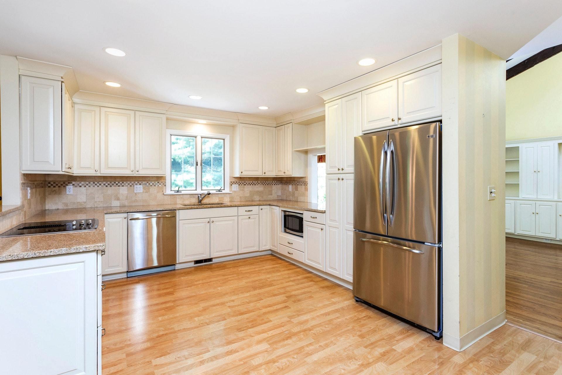65 Maywood Road Darien, CT 06820 - Photo 5 of 14 a kitchen with granite countertop a refrigerator and a stove top oven
