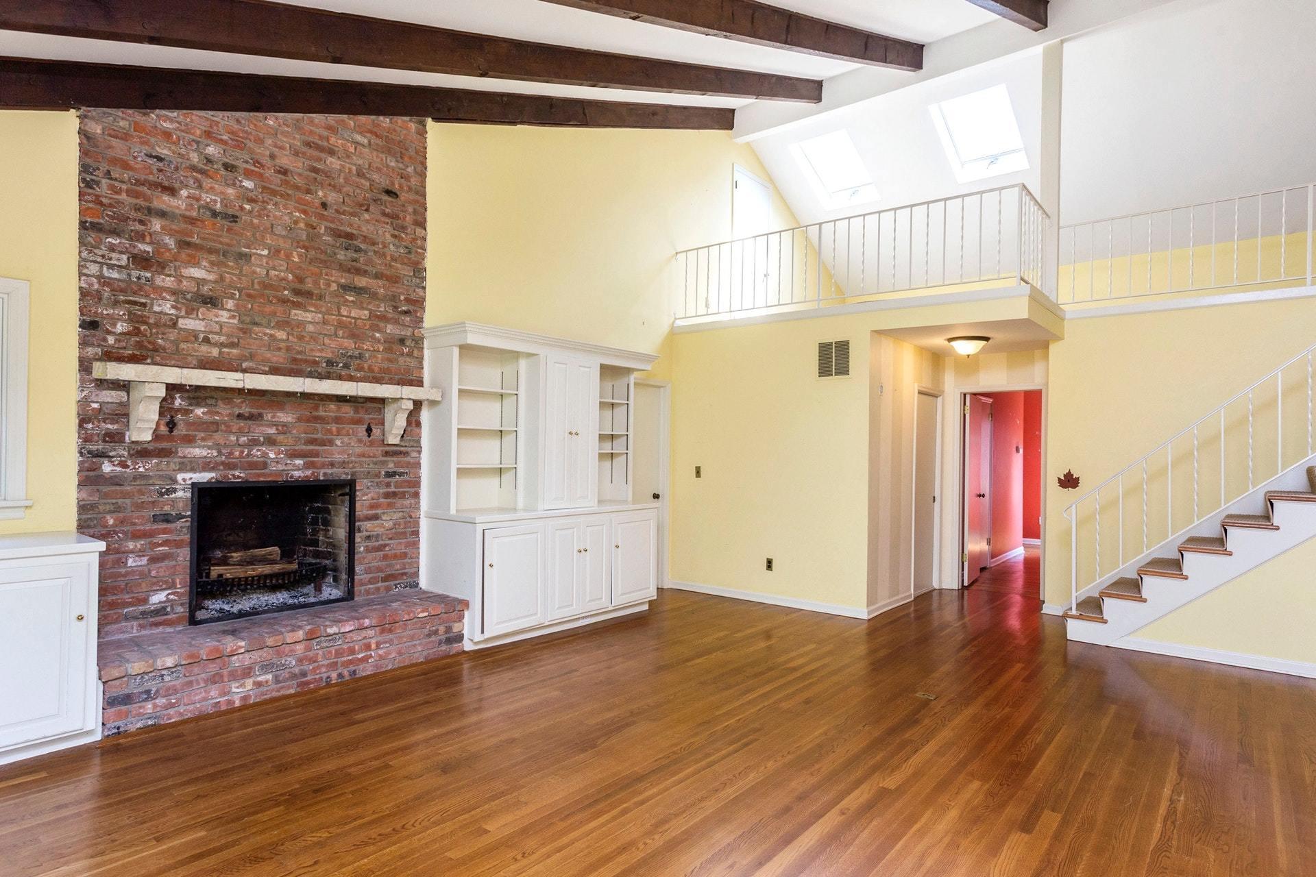 65 Maywood Road Darien, CT 06820 - Photo 7 of 14 a view of a livingroom with wooden floor and a fireplace