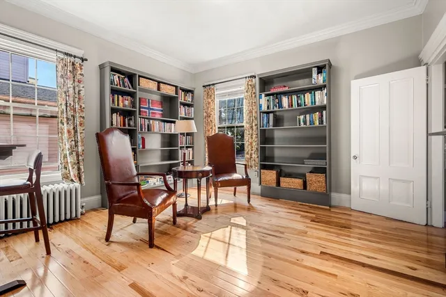 a workspace room with furniture and wooden floor