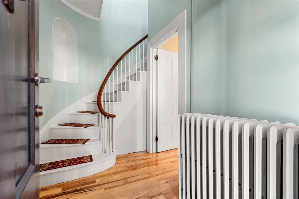 33 Middle Street Gloucester, MA 01930 - Photo 13 of 42 a view of staircase with wooden floor and white walls